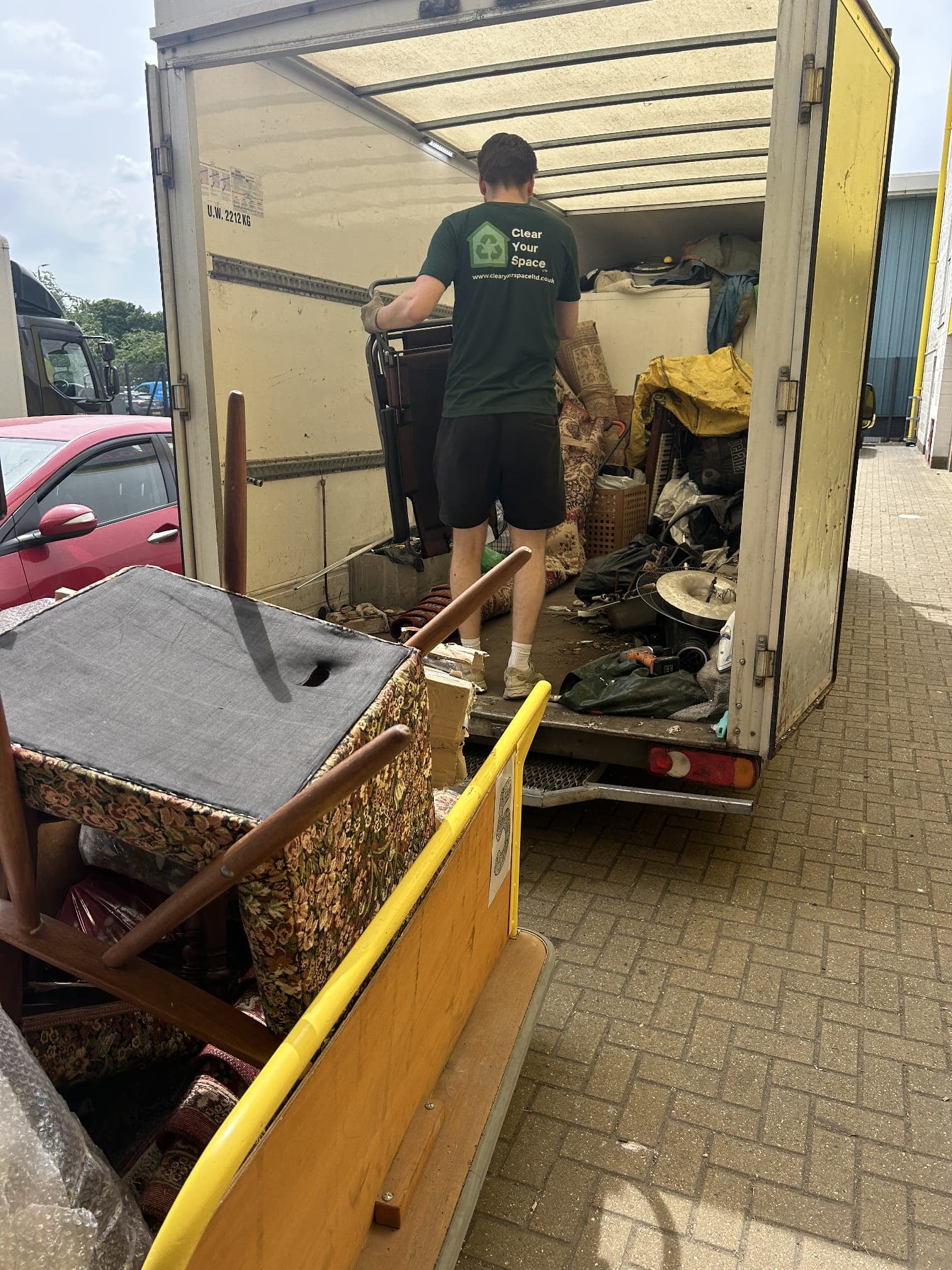 Clear Your Space team loading cleared waste onto our branded van